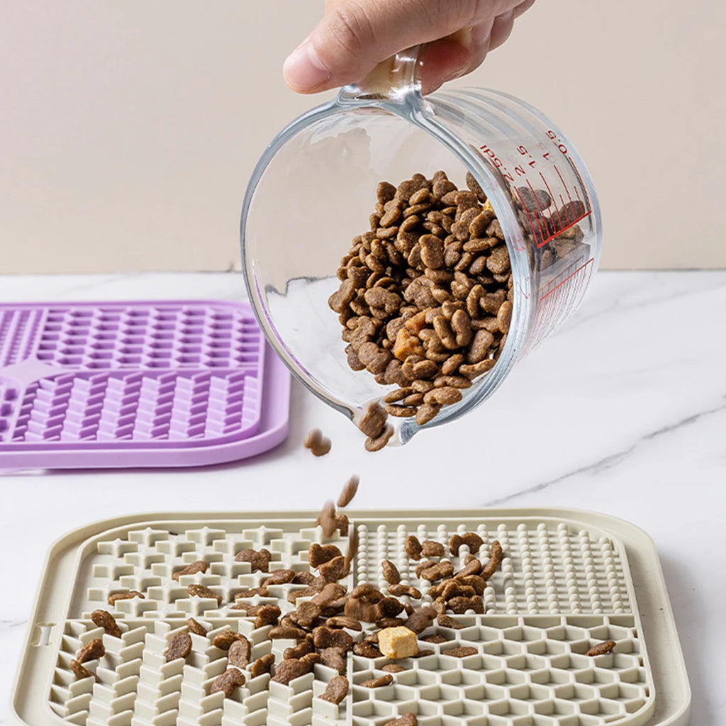 Pouring kibble onto a sage green silicone lick mat slow feeder | Pawnests